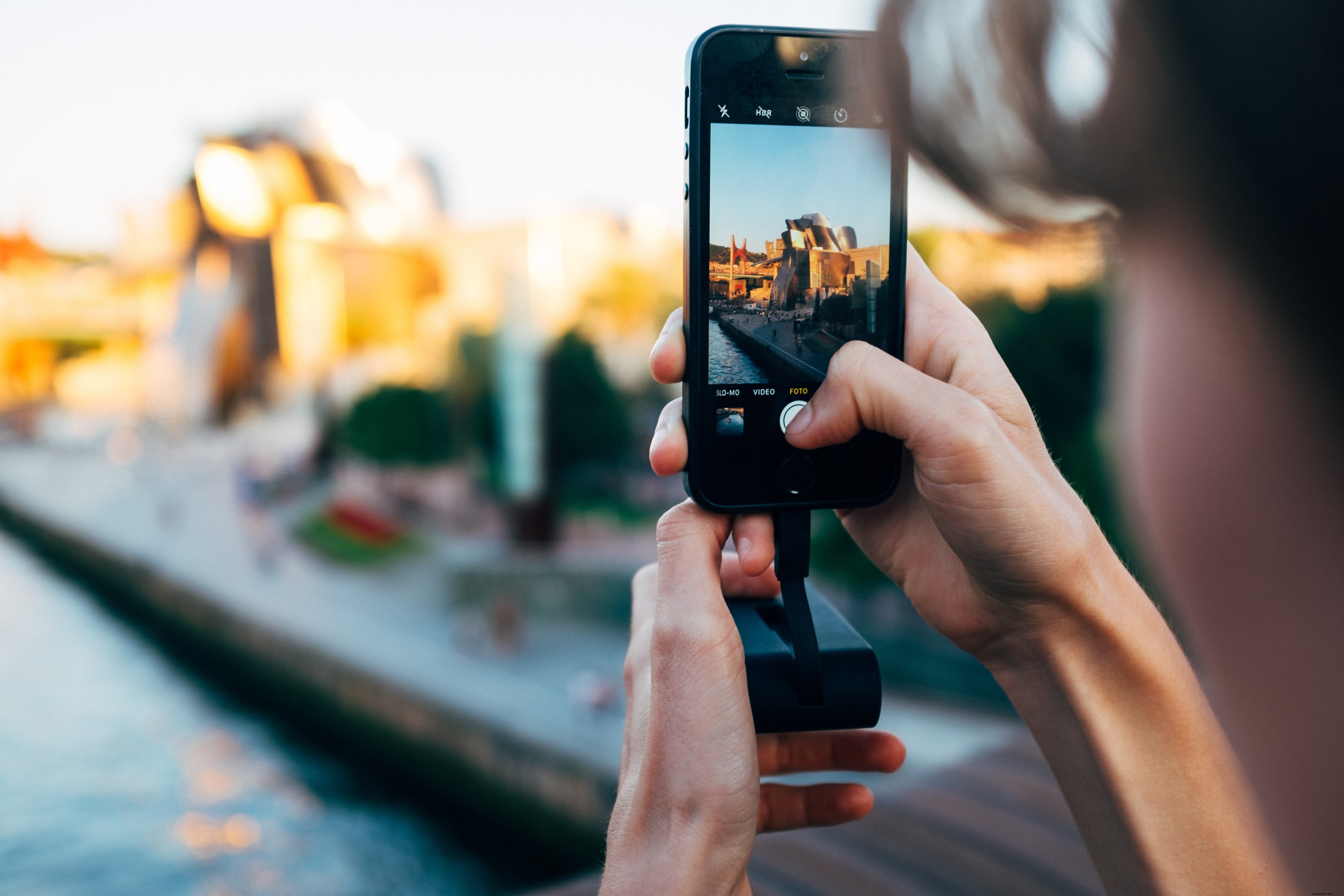 Uma mulher tira um grande prédio de alumínio com a foto do celular