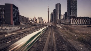 Il treno dei pendolari sfreccia nella foto della città