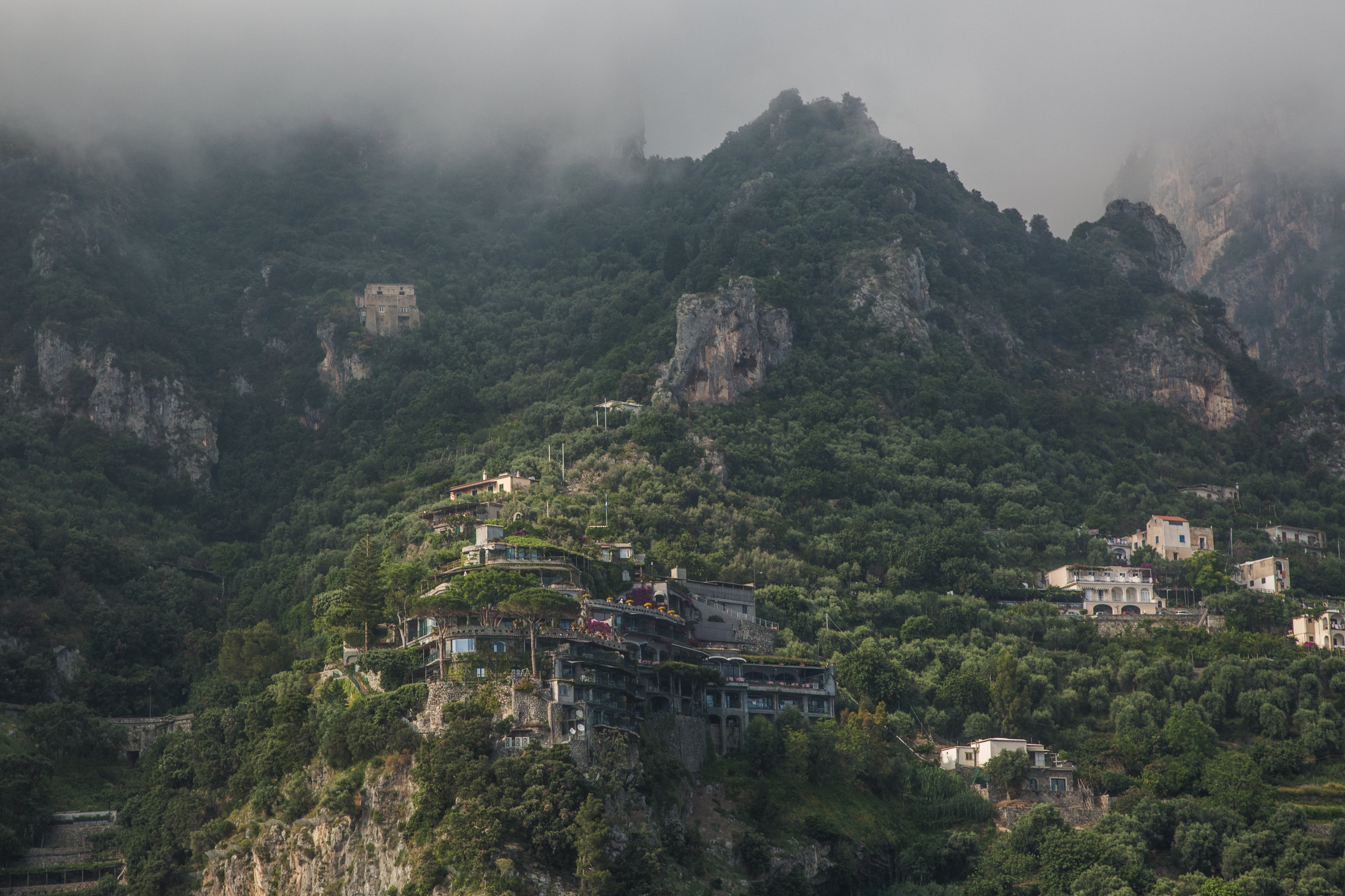 Montagnes brumeuses avec des bâtiments Photo