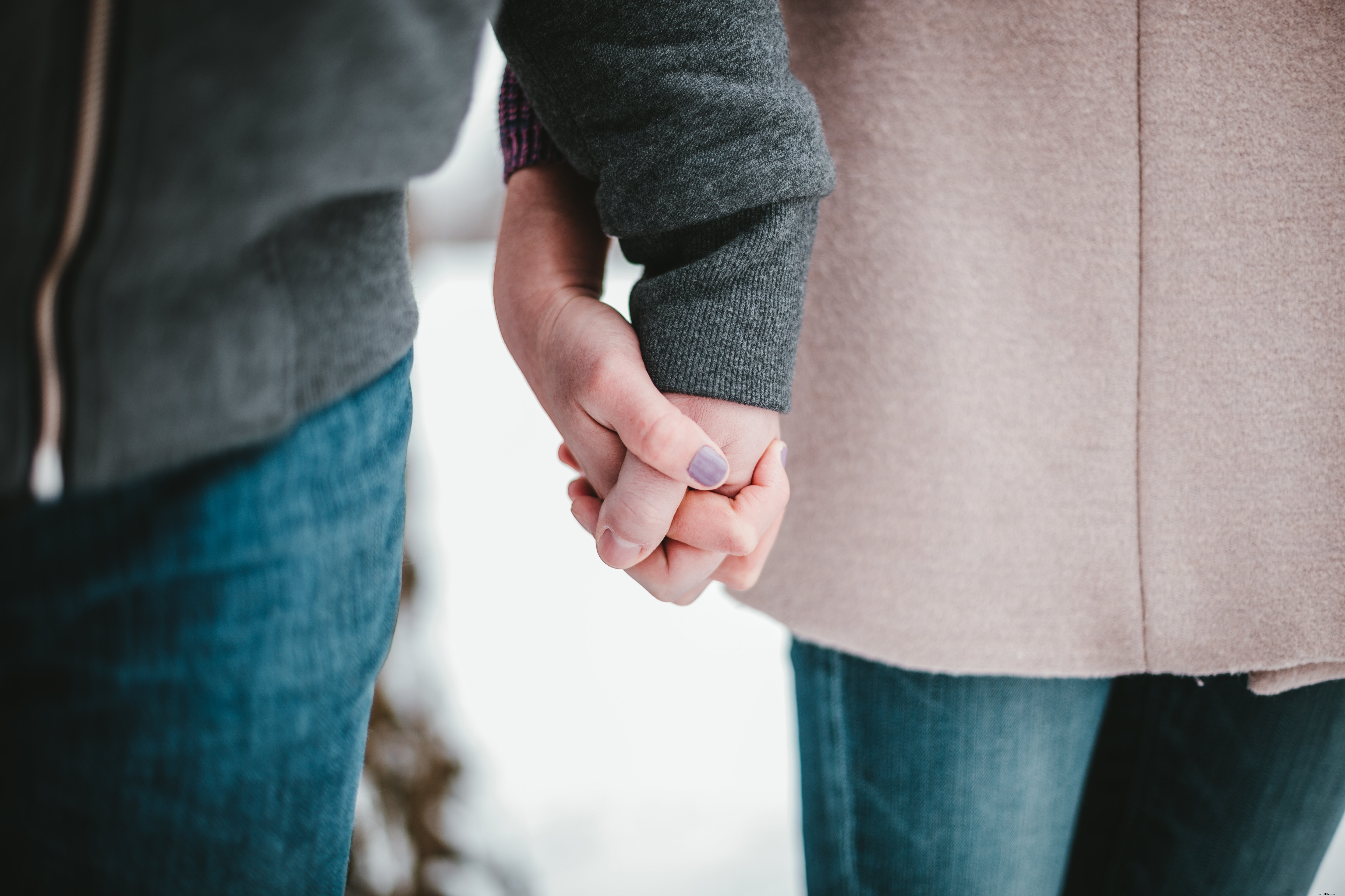 Una coppia che si tiene per mano in inverno foto