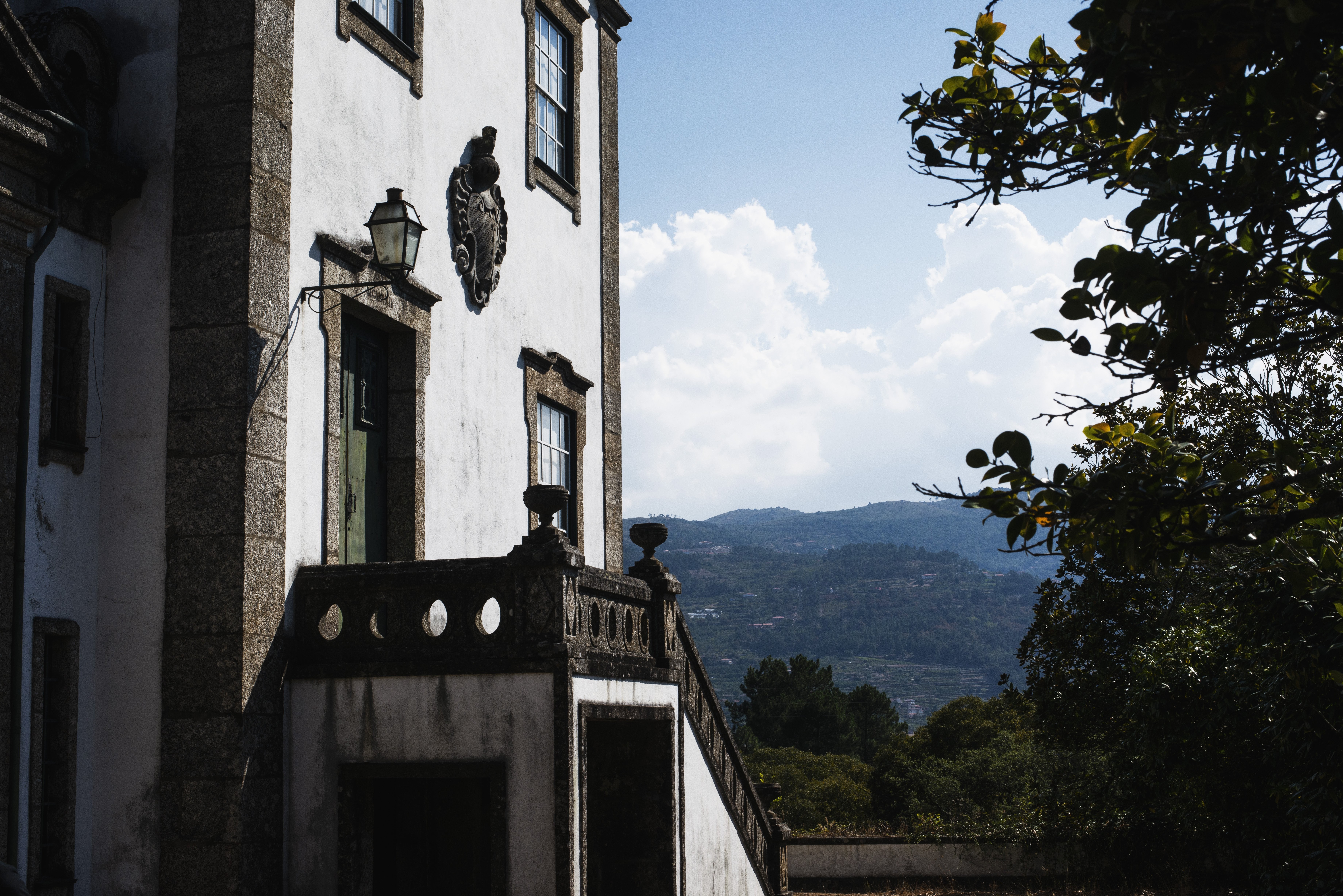 Um edifício histórico nas sombras das árvores vizinhas. Foto 