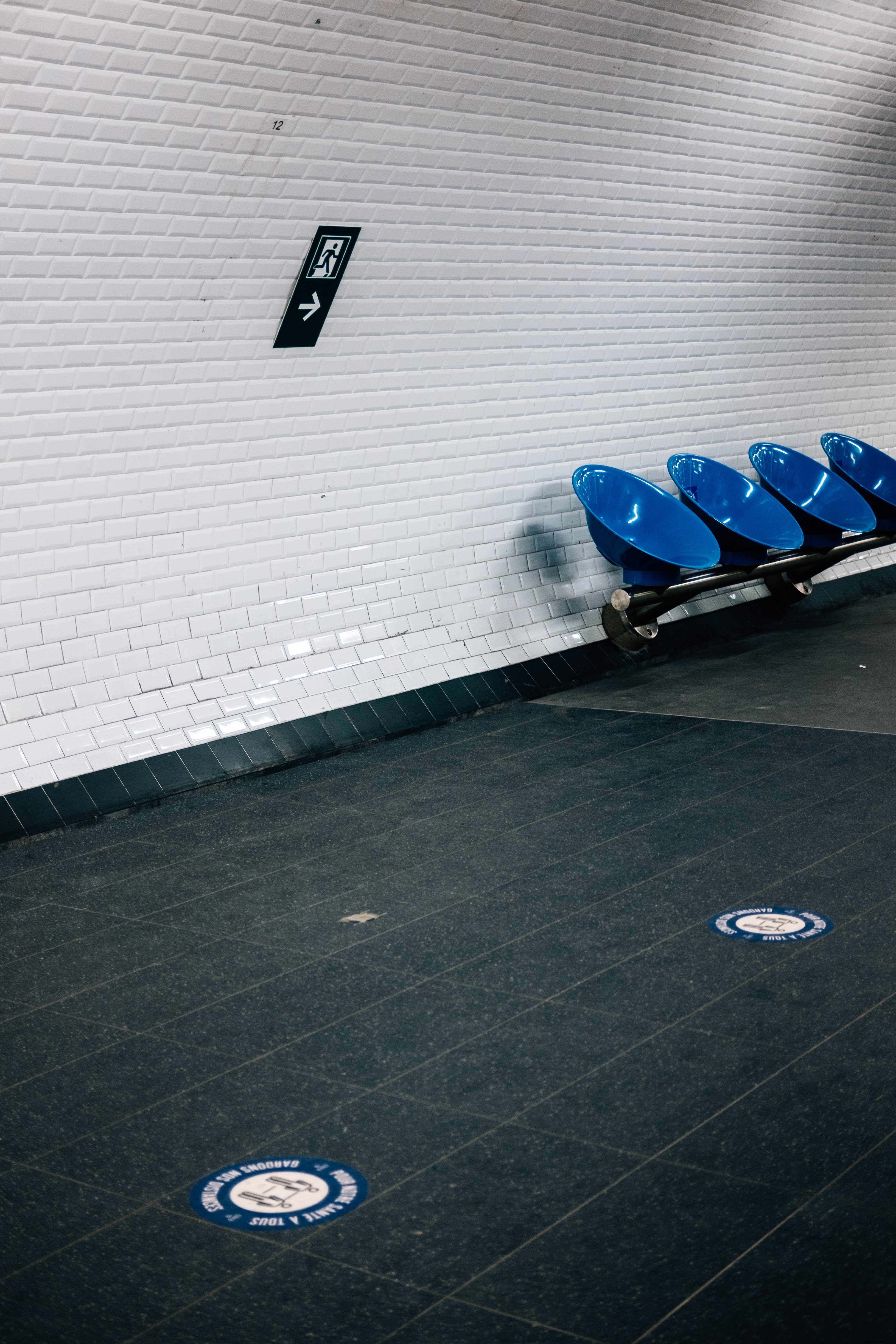 Foto de pared de azulejos blancos y sillas redondas azules 