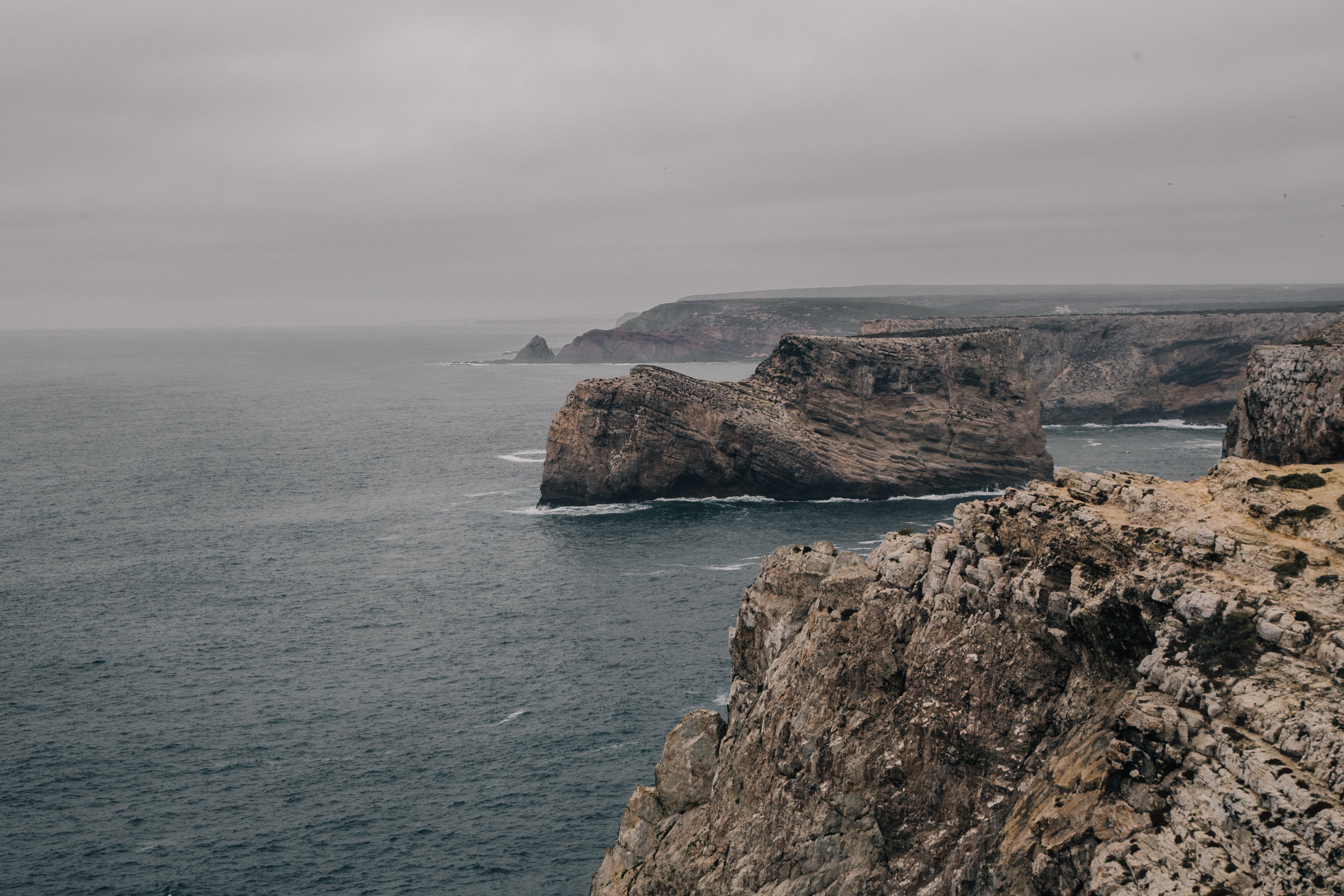 Rocky Cliffs Roll Back from the Cold Grey Sea Photo 