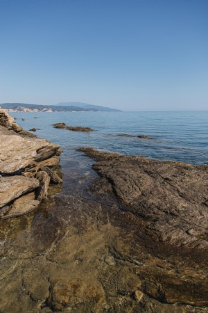 Costa rocosa con mar abierto y cielo azul Foto 