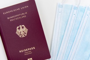 Flatlay de uma foto de passaporte e três máscaras descartáveis 