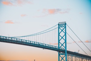 Foto de amanecer suave y colorido sobre un puente de metal 
